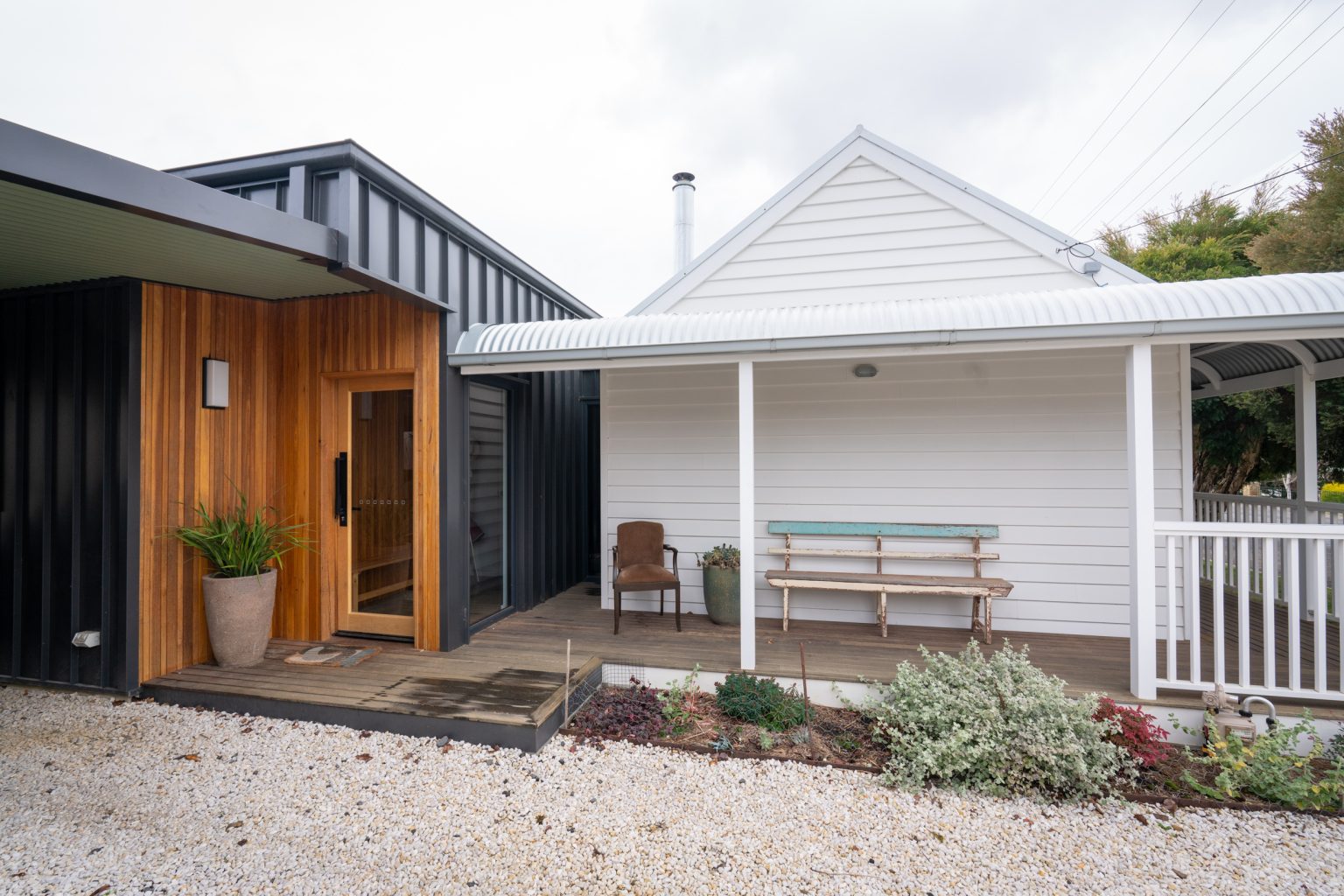 Modern house facade with wooden and metal panels.